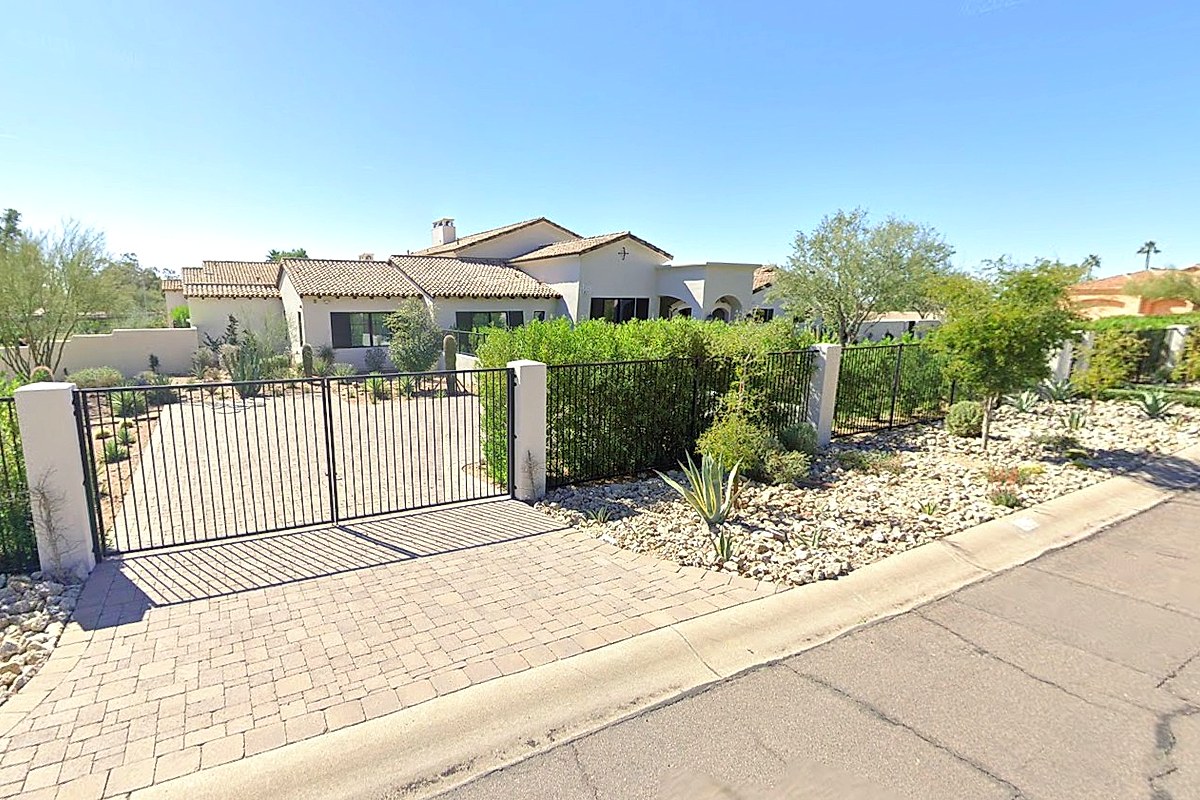 Tree-lined Arcadia street with character homes and Camelback Mountain views