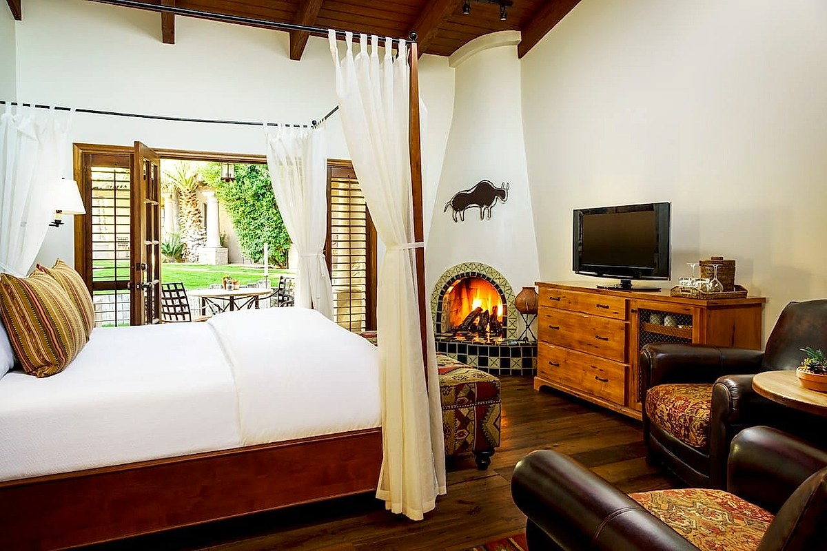 Hacienda-style luxury interior with four-poster canopy bed at a Biltmore property