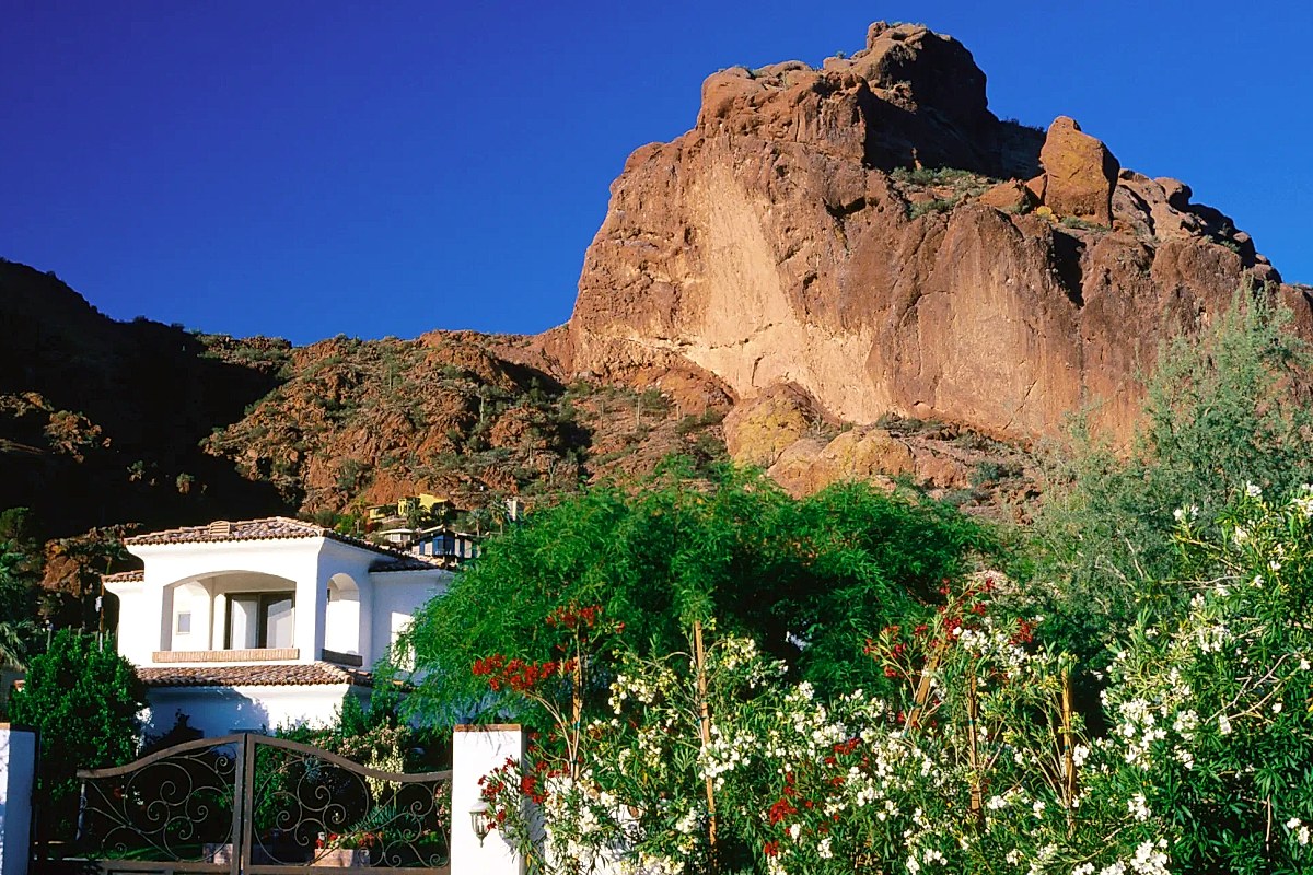 Contemporary glass home integrated into a Camelback Mountain cliff face
