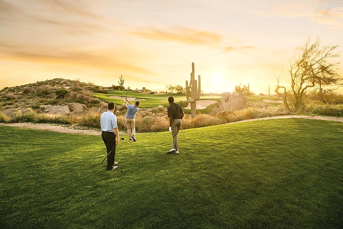 Championship golf course at golden hour with Sonoran Desert mountain backdrop